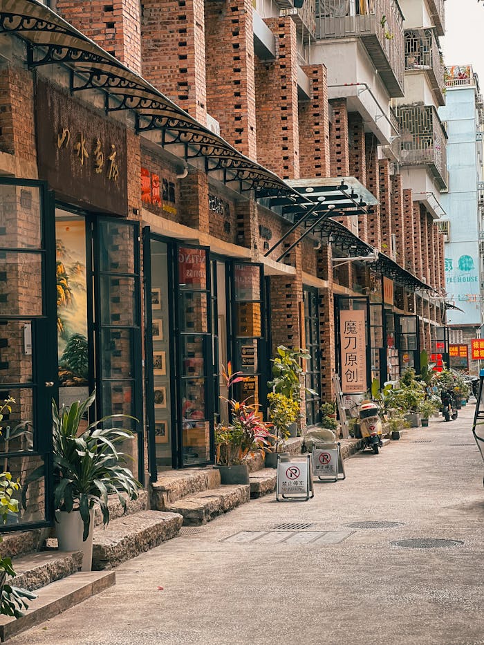 A cozy urban alley lined with rustic brick shops and green plants, perfect for exploring.